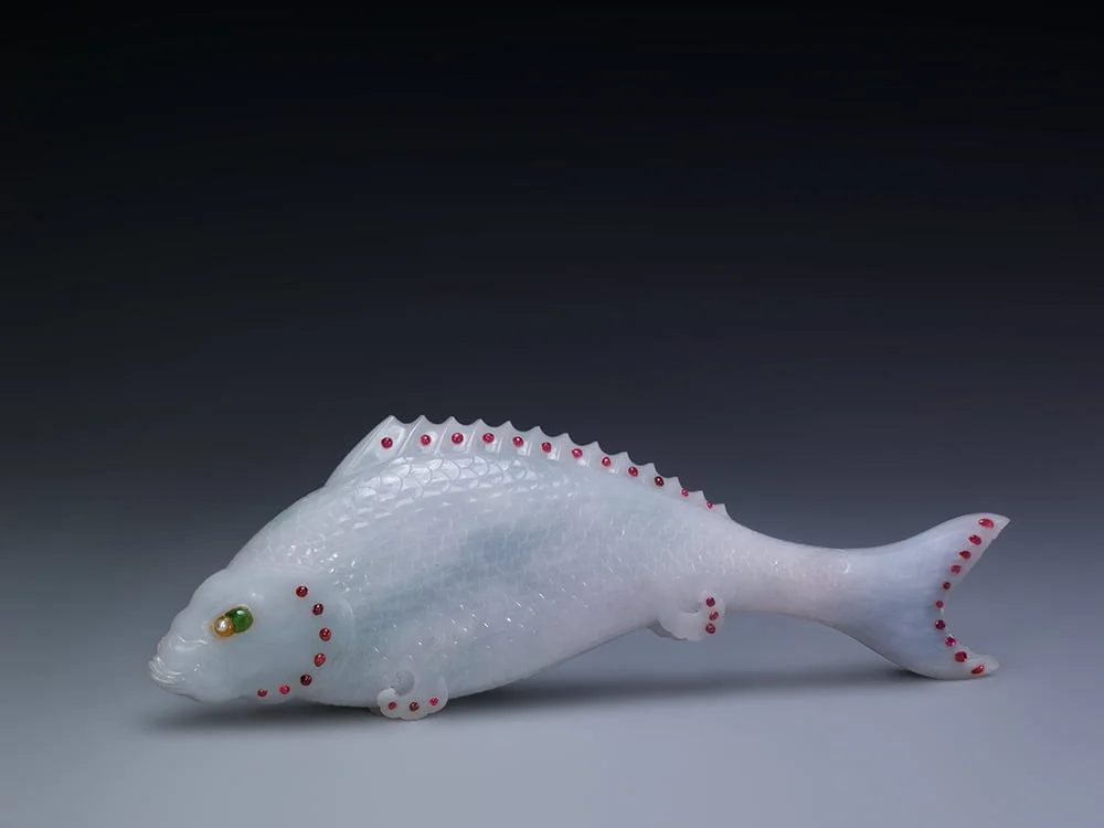 This jade box in the shape of fish embellished with rubies and